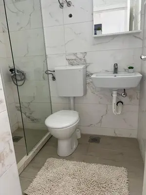 a bathroom with a toilet and a sink at Rasi Luxury Apartments in Ulcinj
