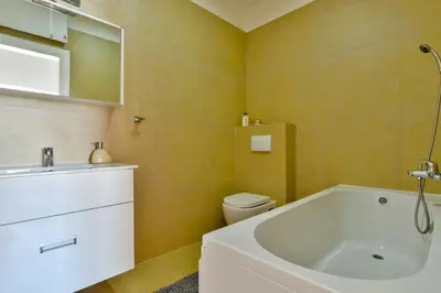 a bathroom with a tub and a toilet and a sink at Lux Apartment Luna in Sveti Stefan