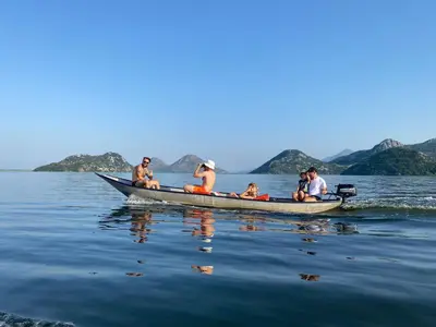 a group of people in a canoe on the water at Lotus House Dodoši in Dodoši
