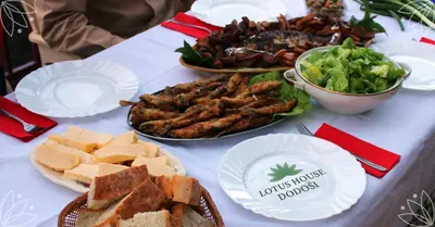 a table with plates of food on a table at Lotus House Dodoši in Dodoši