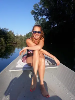a woman in a bikini sitting on the back of a boat at Lotus House Dodoši in Dodoši