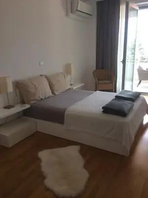 a bedroom with a large bed with a rug at Harmony in Sveti Stefan