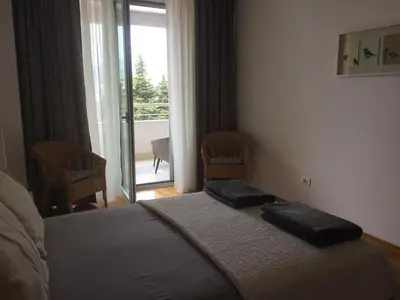 a bedroom with a bed with two pillows on it at Harmony in Sveti Stefan
