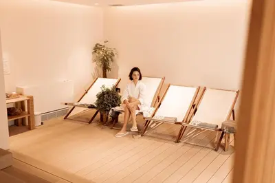 a woman sitting on a chair in a room at Hotel Harmonia by Dukley in Budva
