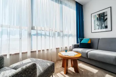a living room with a couch and a table at Hotel Harmonia by Dukley in Budva