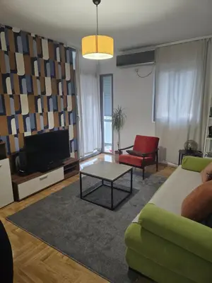 a living room with a couch and a tv at Recently renovated Delta Apartment in Podgorica