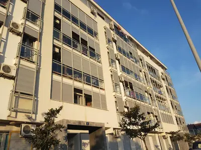 a large building with windows on the side of it at Recently renovated Delta Apartment in Podgorica