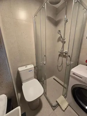 a bathroom with a shower with a toilet and a sink at Recently renovated Delta Apartment in Podgorica
