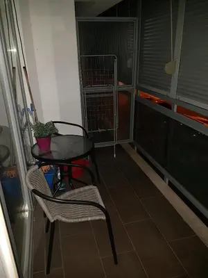 a balcony with a table and chairs and a bird cage at Recently renovated Delta Apartment in Podgorica