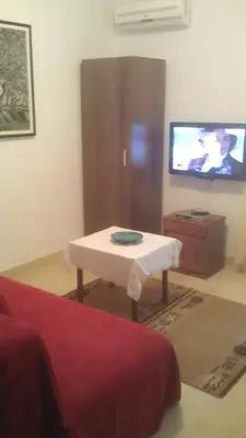 a living room with a coffee table and a tv at Apartments Djakonovic in Ulcinj