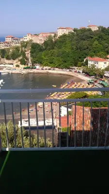 a view of a beach from a balcony at Apartments Djakonovic in Ulcinj