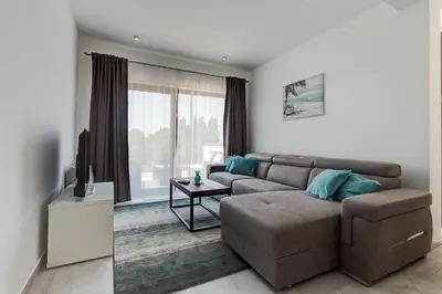 a living room with a couch and a television at Villa Zen Port in Petrovac na Moru