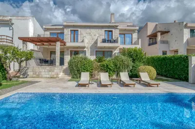 a villa with a swimming pool in front of a house at Villa Zen Port in Petrovac na Moru