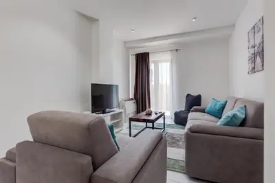 a living room with two couches and a television at Villa Zen Port in Petrovac na Moru