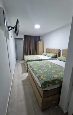 a hotel room with two beds and a television at Apartmani Maja in Bar