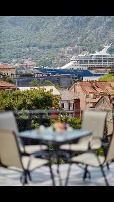 a table and chairs sitting on top of a balcony at Central Magik Apartments in Kotor