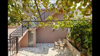 a patio with a table and chairs and a staircase at Central Magik Apartments in Kotor