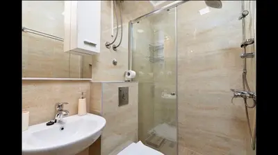a bathroom with a shower and a sink and a toilet at Central Magik Apartments in Kotor