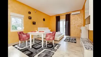 a living room with a white table and chairs at Central Magik Apartments in Kotor