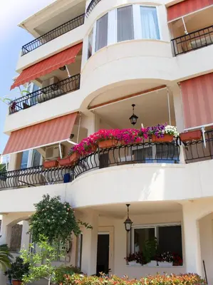 an apartment building with flowers on the balconies at Apartments Grabovica in Bar