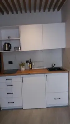a kitchen with white cabinets and a sink at Apartments Grabovica in Bar