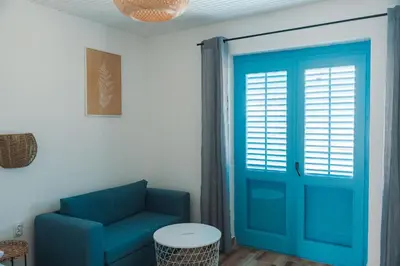 a blue door in a room with a blue couch at FKK Ada Bojana in Ulcinj