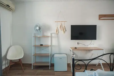 a room with a tv and a desk and a chair at FKK Ada Bojana in Ulcinj