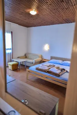 a bedroom with a bed and a couch in a room at FKK Ada Bojana in Ulcinj