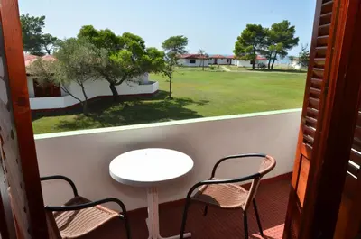a balcony with a table and two chairs and a table at FKK Ada Bojana in Ulcinj
