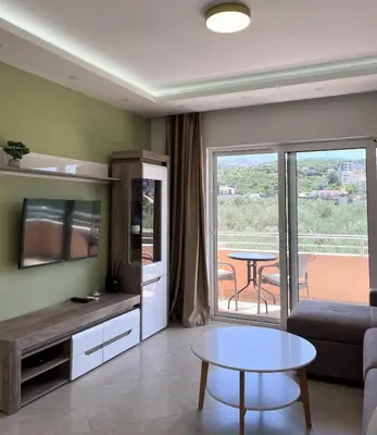 a living room with a couch and a table at Apartments Aura in Utjeha