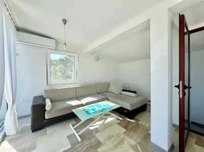 a living room with a couch and a table at Green Villa in Olives in Bar