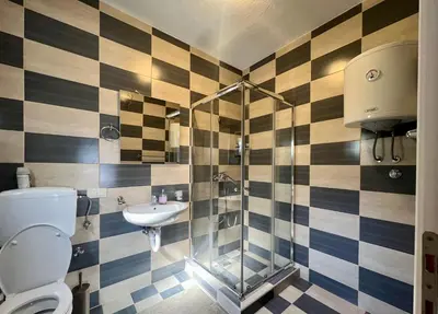 a bathroom with a shower and a toilet and a sink at Green Villa in Olives in Bar