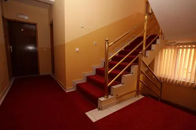 a staircase in a building with a red carpet at Apartments Memidz in Budva