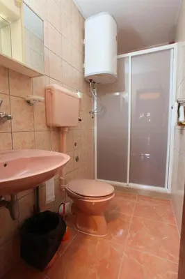 a bathroom with a toilet and a sink and a shower at Apartments Memidz in Budva
