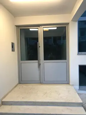 a pair of double doors on a house at Apartmani Belma in Dobra Voda