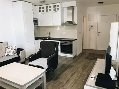a living room with a couch and a kitchen at Apartmani Belma in Dobra Voda