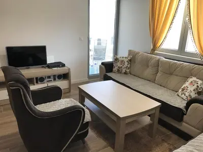 a living room with a couch and chairs and a table at Apartmani Belma in Dobra Voda