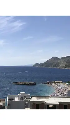 a view of a beach with a crowd of people at Apartmani Belma in Dobra Voda