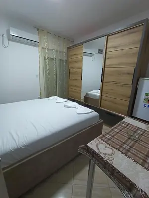a bedroom with a bed and a mirror and a table at Accommodation Milla in Ulcinj