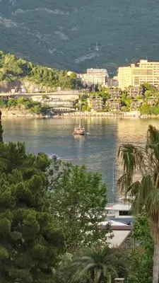 a river with a boat in the middle of a city at Apartments M Palace in Budva