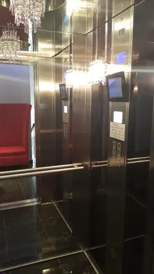 a ticket machine in a room with a red chair at Apartments M Palace in Budva