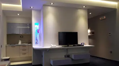 a room with a tv on a counter with a kitchen at Apartments M Palace in Budva