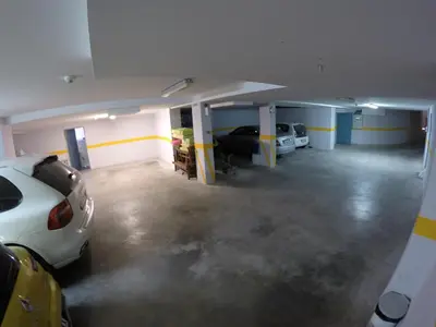 an empty garage with two cars parked in it at Apartments M Palace in Budva