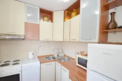 a kitchen with white cabinets and a sink at Dubravcevic Residence in Tivat