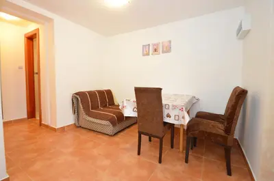 a living room with a table and two chairs at Dubravcevic Residence in Tivat