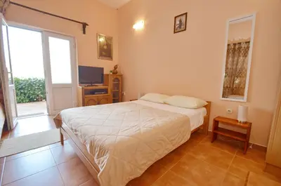 a bedroom with a bed and a television in it at Dubravcevic Residence in Tivat