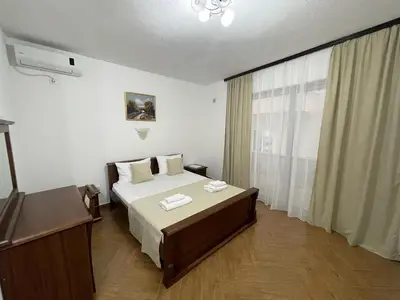 a bedroom with a large bed and a window at Apartmani Sejla in Dobra Voda