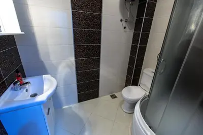 a bathroom with a sink and a shower and a toilet at Apartmani Sejla in Dobra Voda