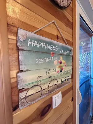 a door with a sign that says happiness is not destination at Cottage Ajna - Ada Bojana in Ulcinj