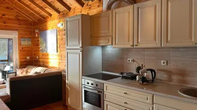 a kitchen with white cabinets and a stove top oven at Cottage Ajna - Ada Bojana in Ulcinj